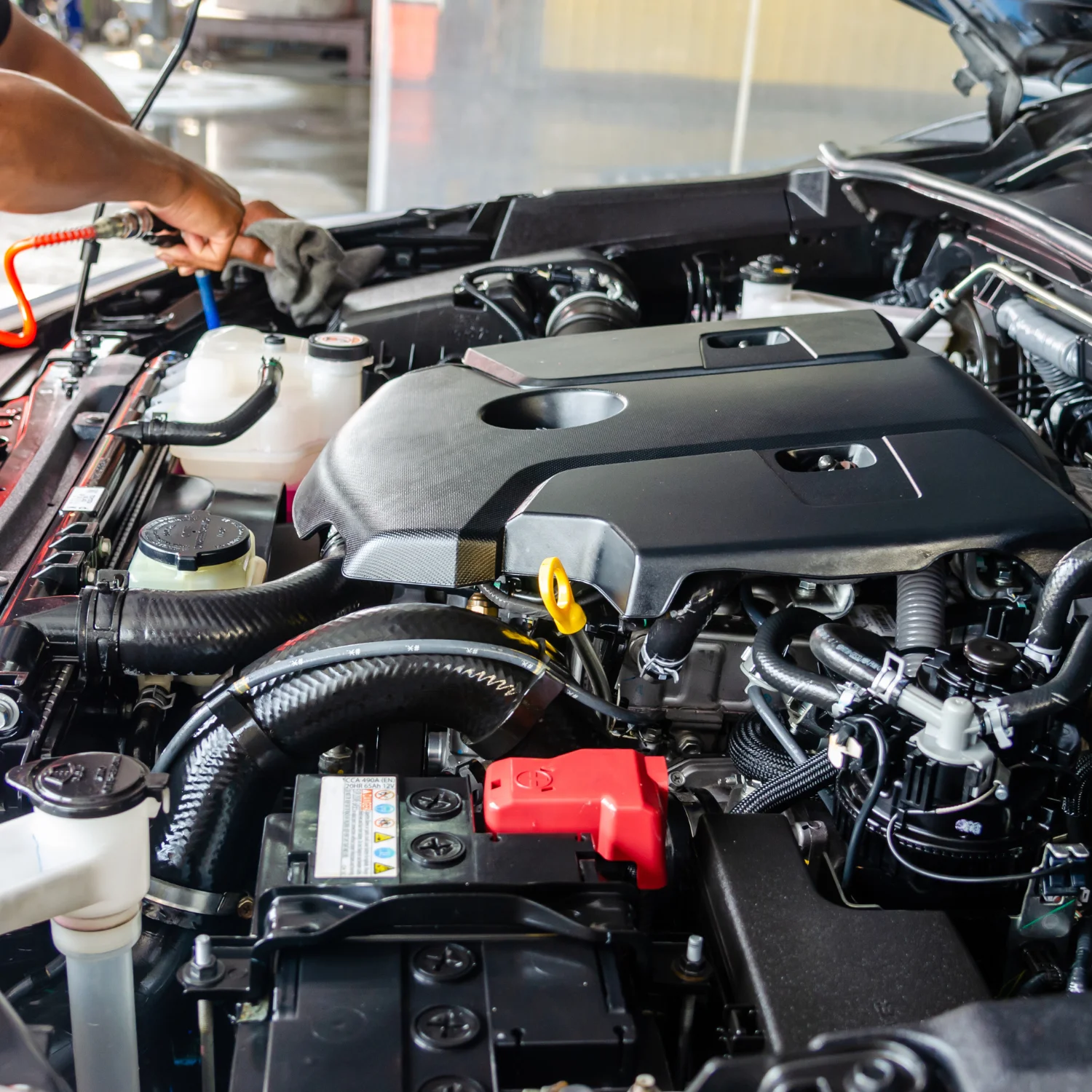 man fixing the car engine