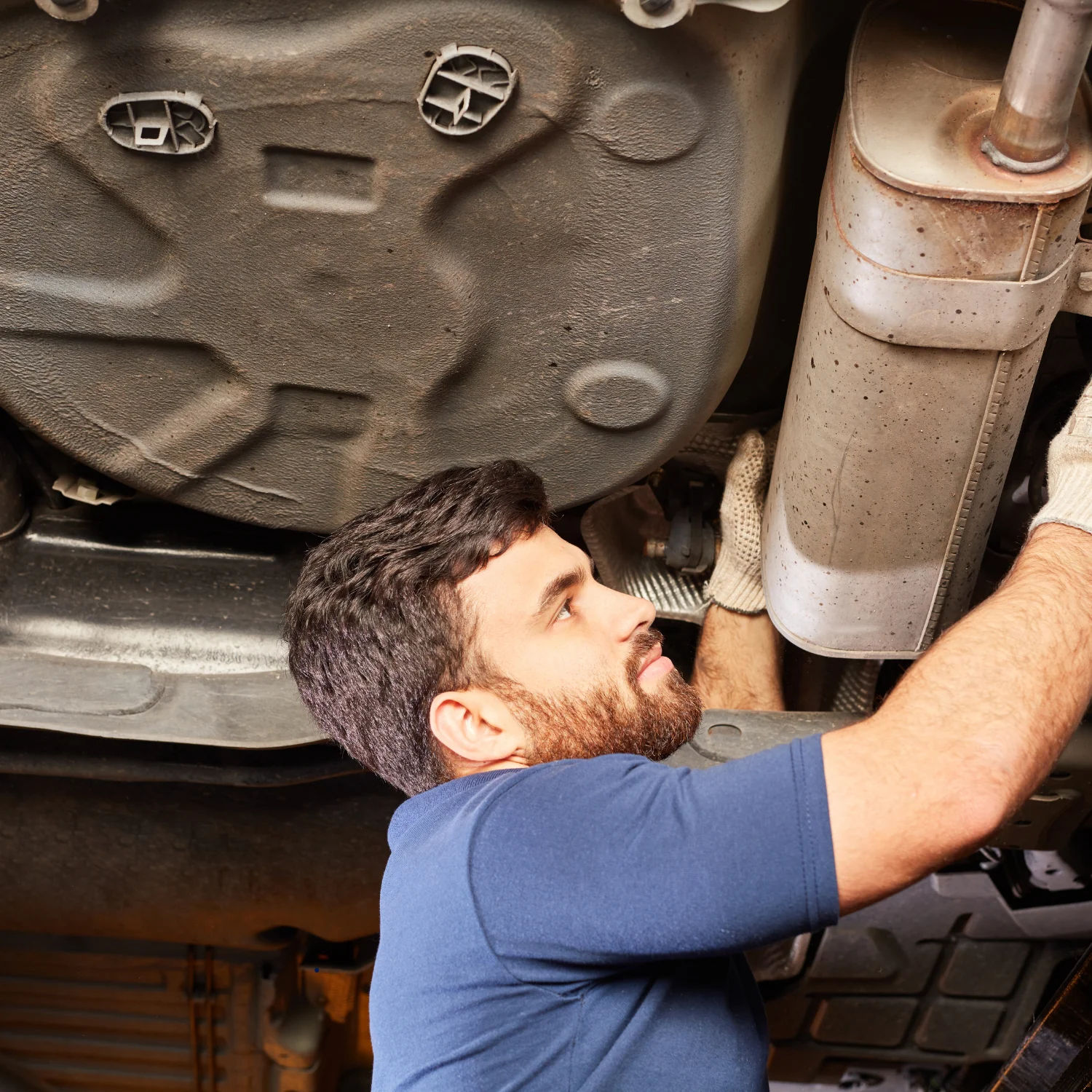 engineer in blue shirt holding the exhaust