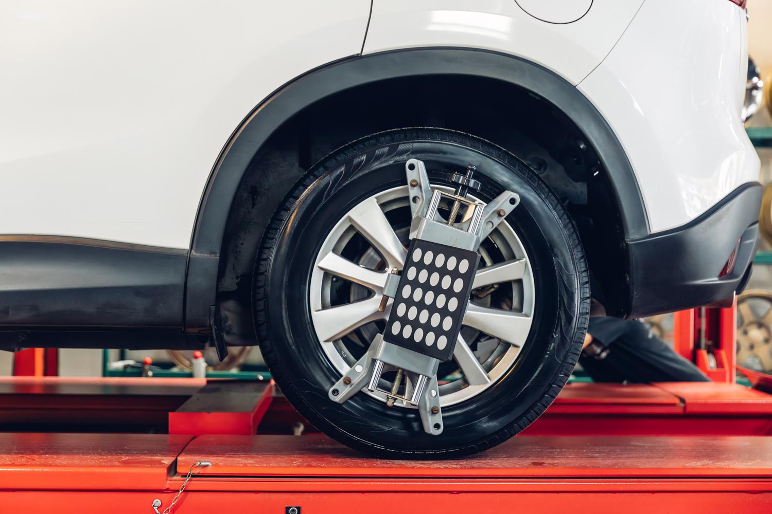 A sensor on wheels during wheel angle adjustment or spooring